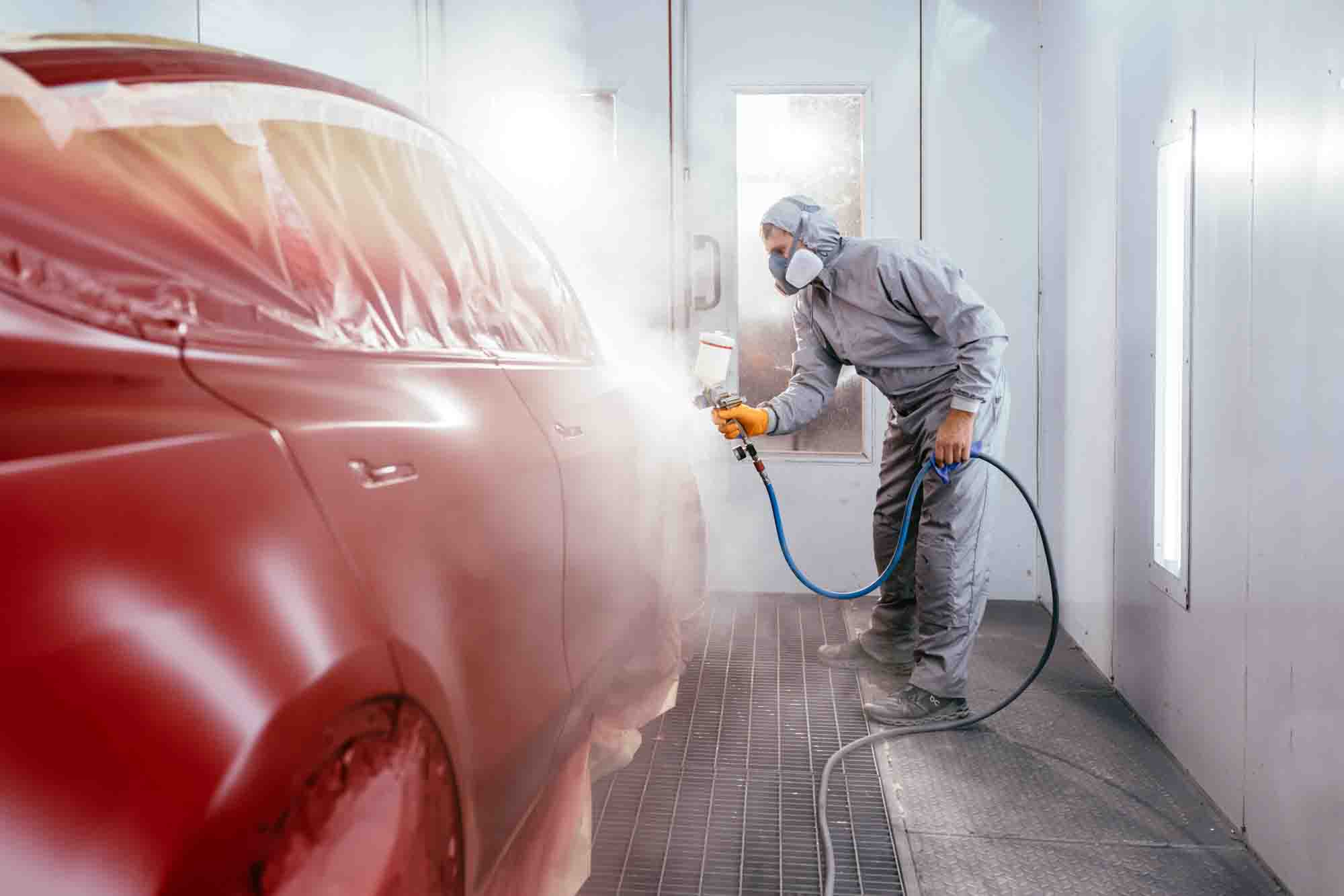 painter-in-booth-spraying-red-suv-auto-paint-repair-action-colors-